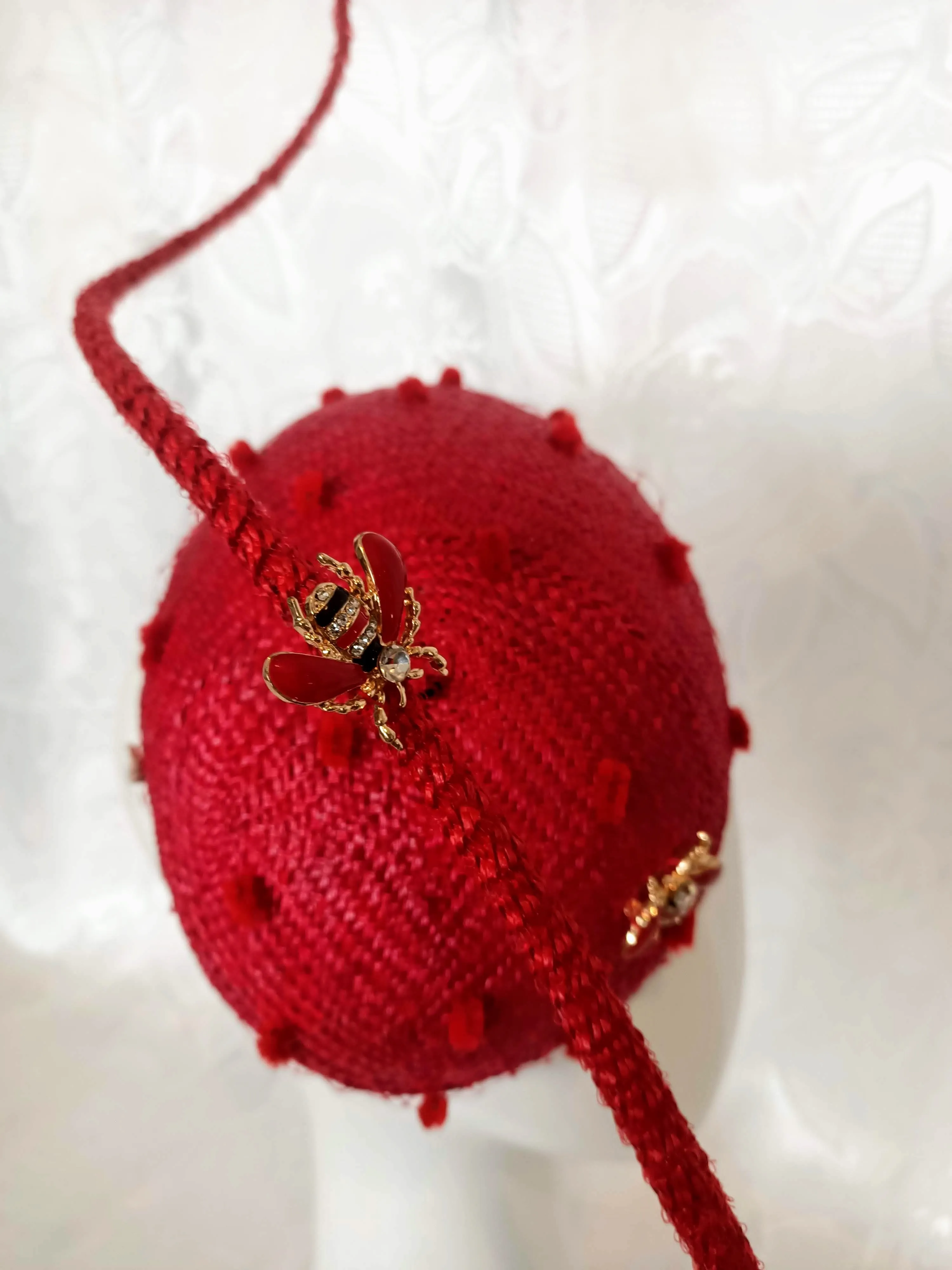 Red Straw Fascinator with Floating Quill & Ladybug Brooches